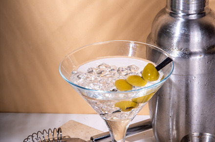 Classic martini cocktail with olive, a Food & Drink Photo by Rimma