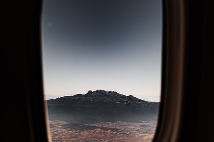 View of the mountain through the window of the plane., a Transportation Photo by Rov.7