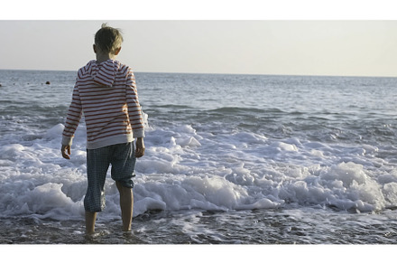 Boy on sea with big waves. Creative, a Person Photo by Media Whale Stock
