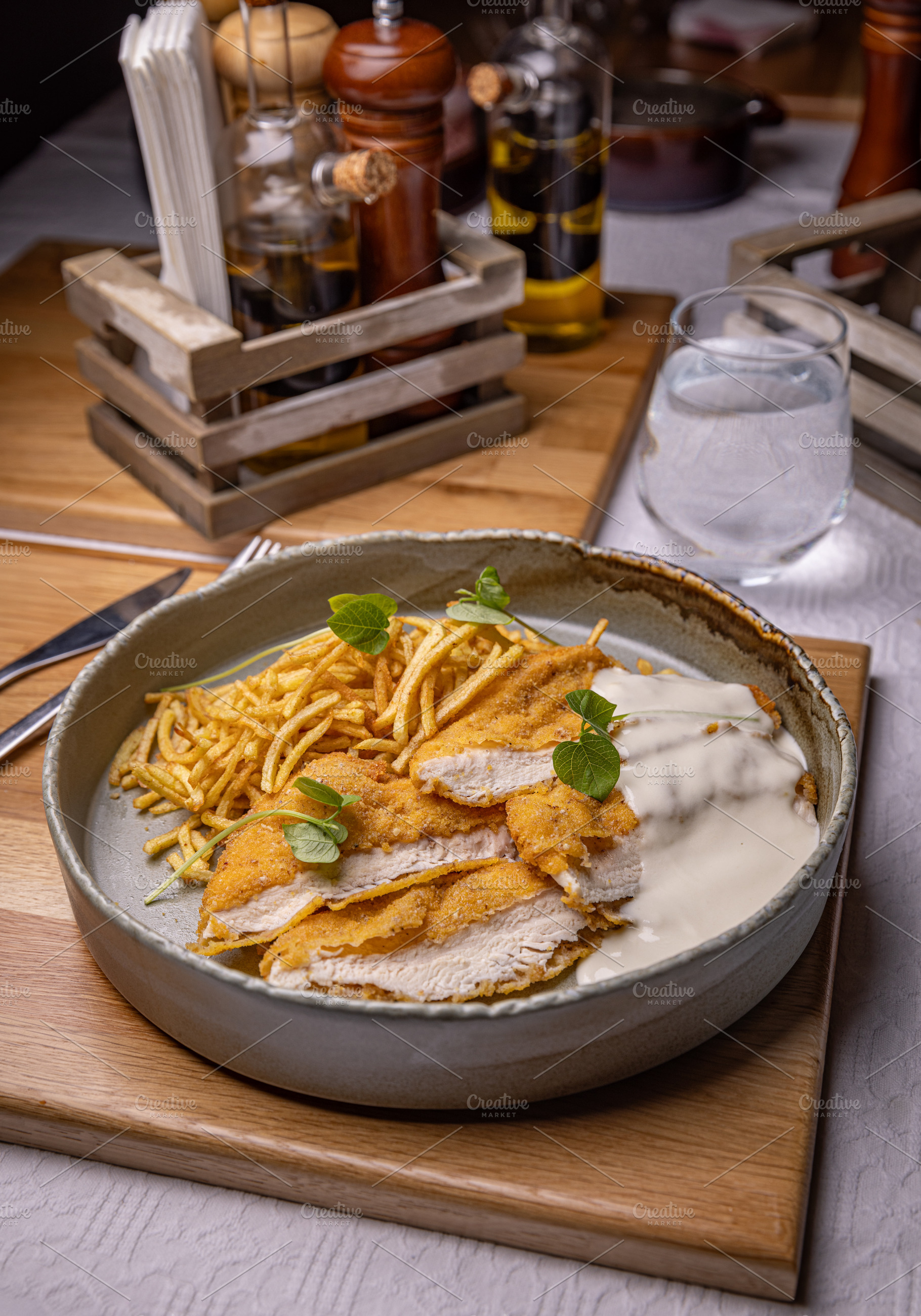 Breaded chicken breast with white sauce, a Photo by Grafvision photography