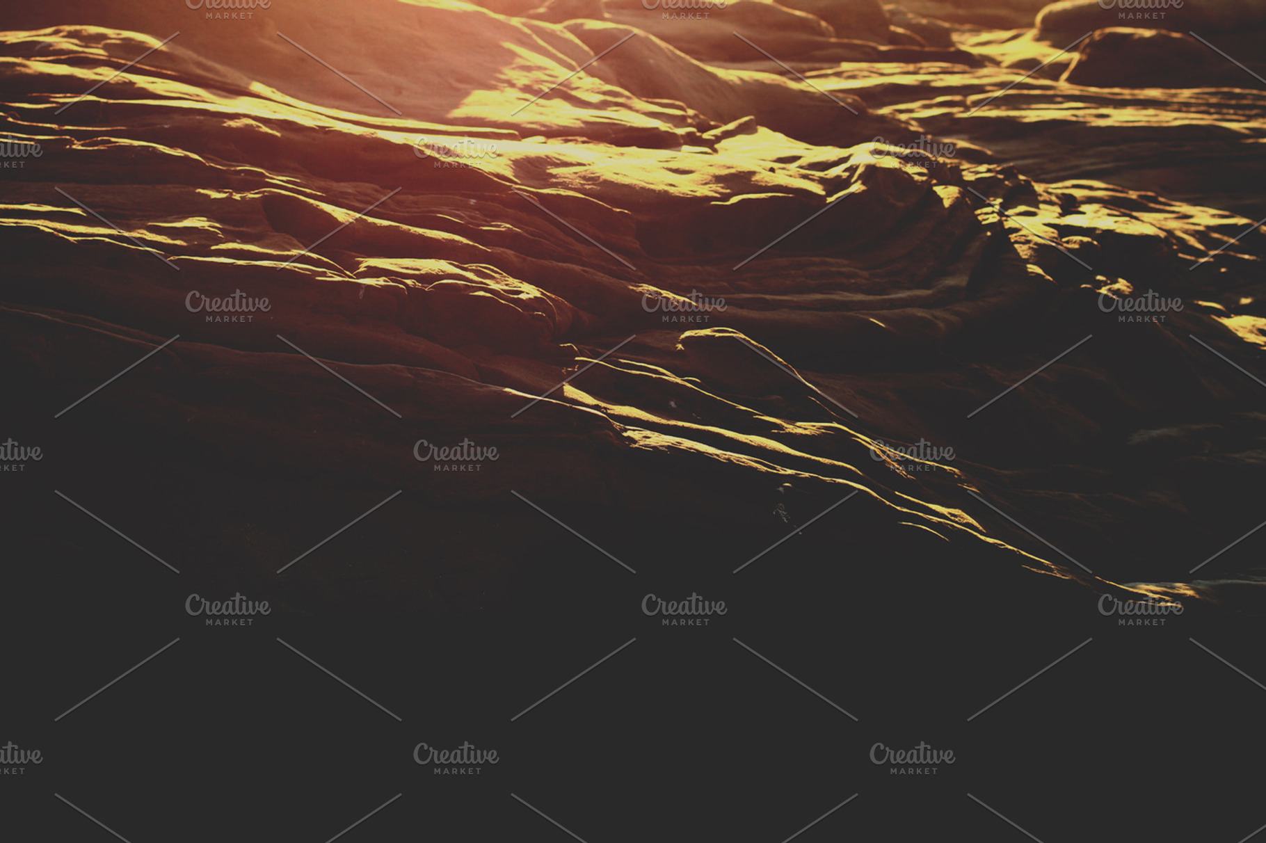 Coastal Rocks With Light Flare Containing Coast Rocks And Sky