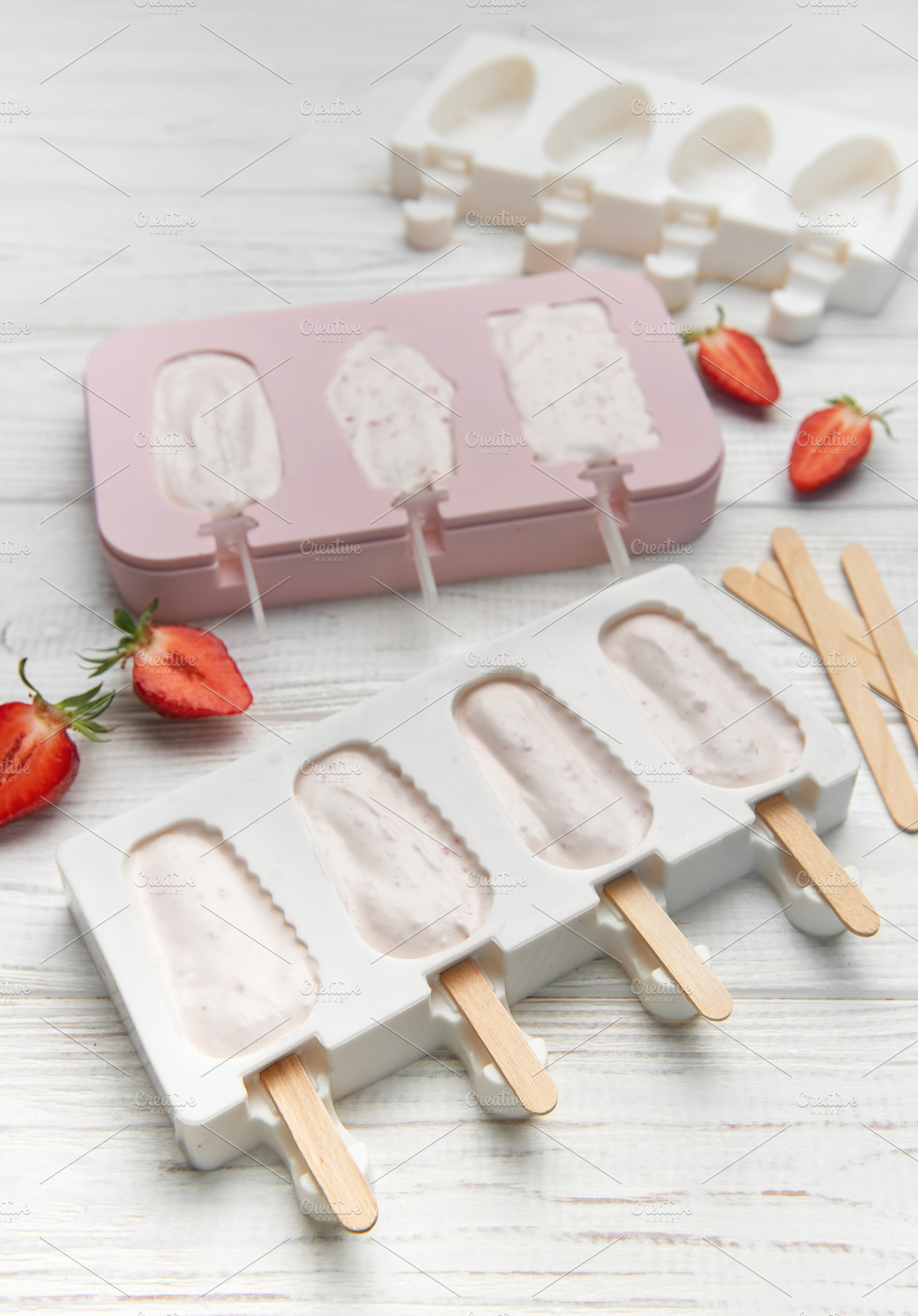 Preparing homemade strawberry ice cream bars in silicone molds, a Food & Drink Photo by Olena Rudo