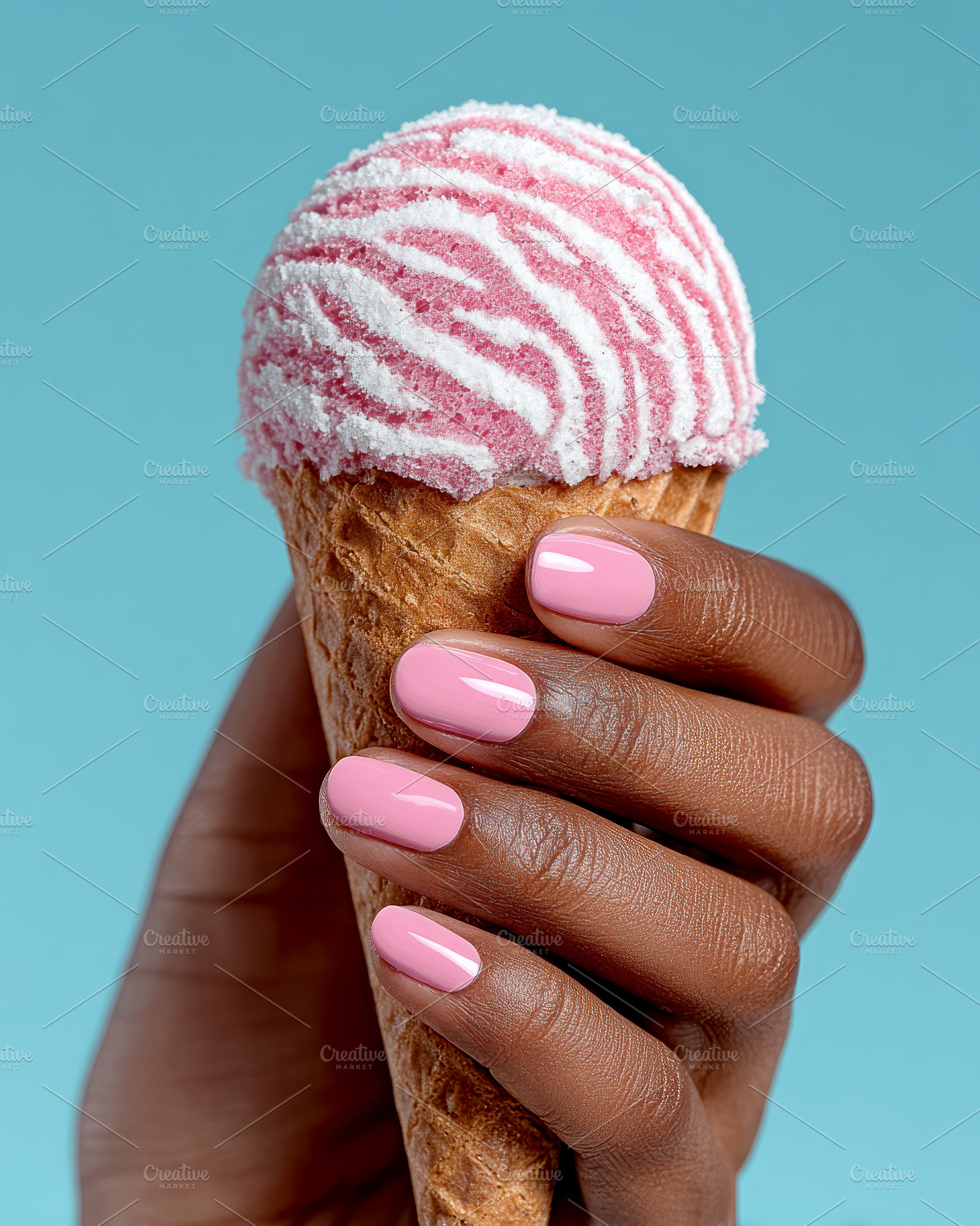 Pink and white zebra-striped ice cream scoop in a waffle cone he, a Photo by José Manuel Gelpi
