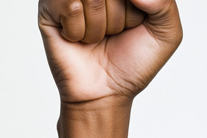 Fist raised in solidarity at protest, a Photo by Beautiful things