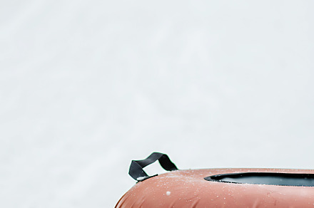Snow tubing on a snowy hill.