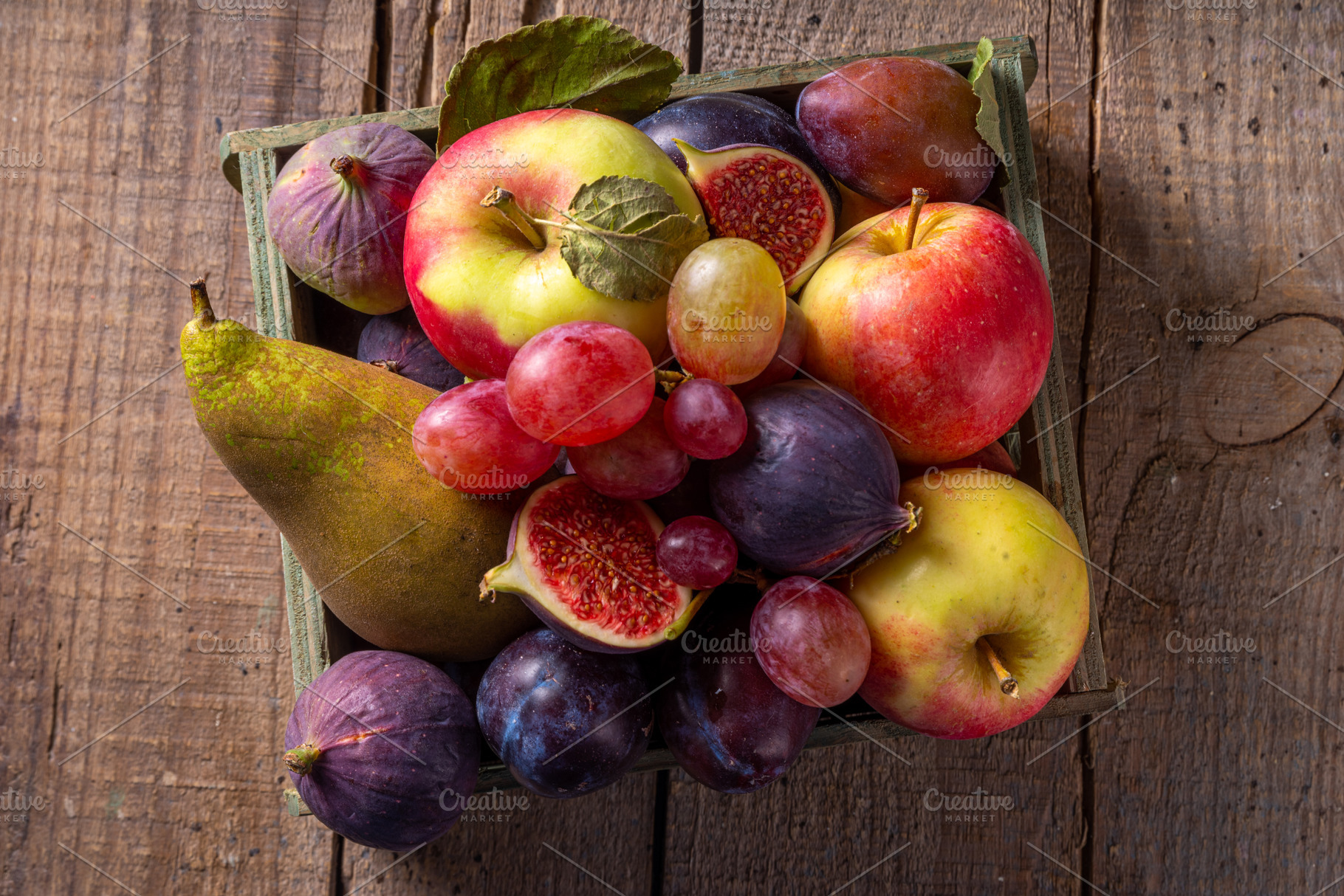 Autumn fruit assortment on wooden background, a Food & Drink Photo by Rimma