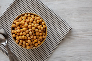 Organic Raw Canned Chickpeas in a Bowl, top view. Copy space., a Food & Drink Photo by LiudmylaChuhunova
