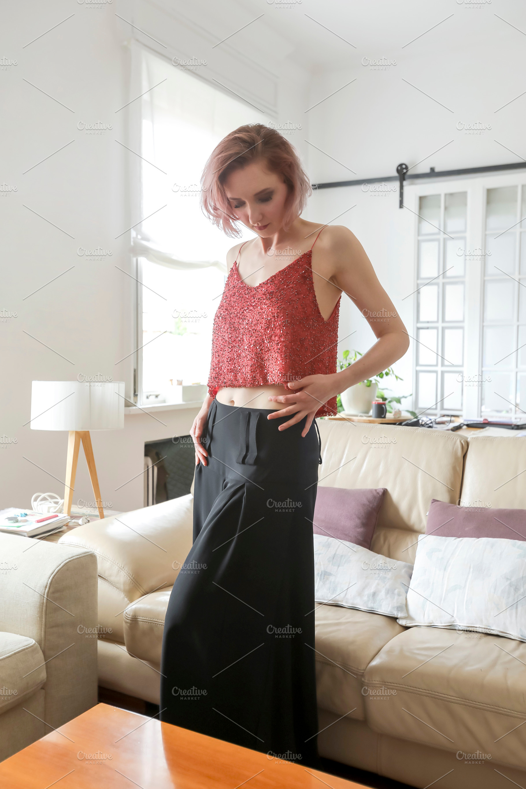A Red-haired woman in fashion clothes standing at home, a Person Photo by RF Images