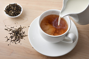 Cup of hot tea and milk on a wooden tray, a Food & Drink Photo by Davizro's Market