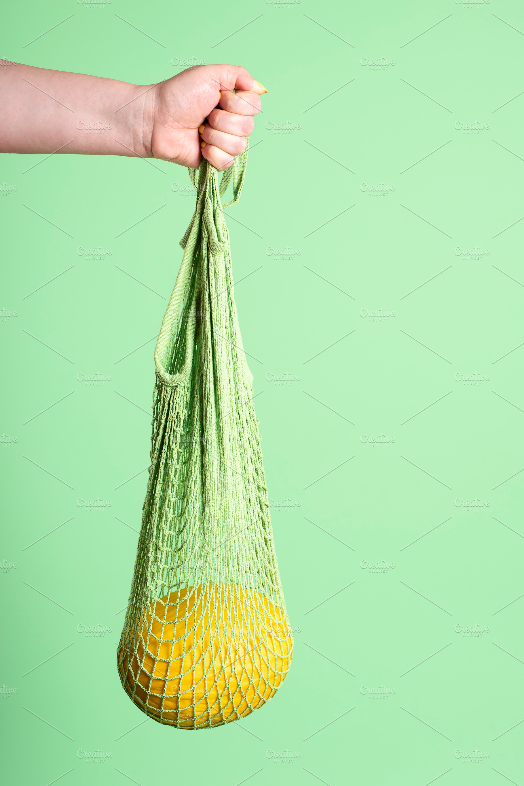 Yellow melon hanging in reusable mes, a Food & Drink Photo by YesPhotographers