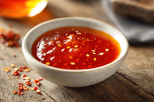 Bowl of spicy sauce with red pepper flakes, a Food & Drink Photo by AlyaAnd
