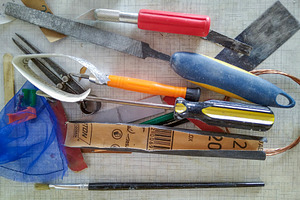 Scattered hand tools on white grid workspace, a Nature Photo by DanFLCreativo
