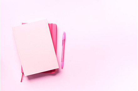 Top view of open pink notebook on