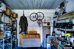 Garage with various tools, wooden materials, and mechanical comp, an Industrial Photo by DanFLCreativo
