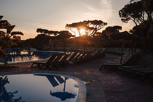 Sunset resort pool with loungers, a Sports & Recreation Photo by SkyNext