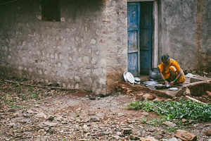 Woman cleaning dishes in India