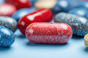 Capsules on blue surface, a Photo by Beautiful things