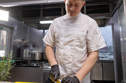 Chef slicing fresh carrot, a Photo by Grafvision photography