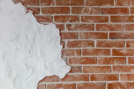 brick wall with a piece of white plaster, a Wallpaper Photo by Photostock