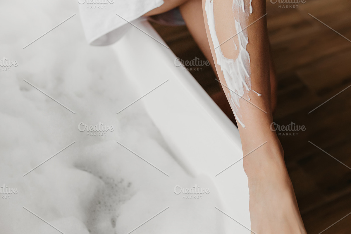 Young woman shaving legs using safety razor, removing hair, making depilation i, a Photo by Prostock-Studio (Photo 1 of 2)