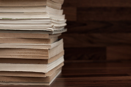 Books on table containing books, stack of books, and book reading