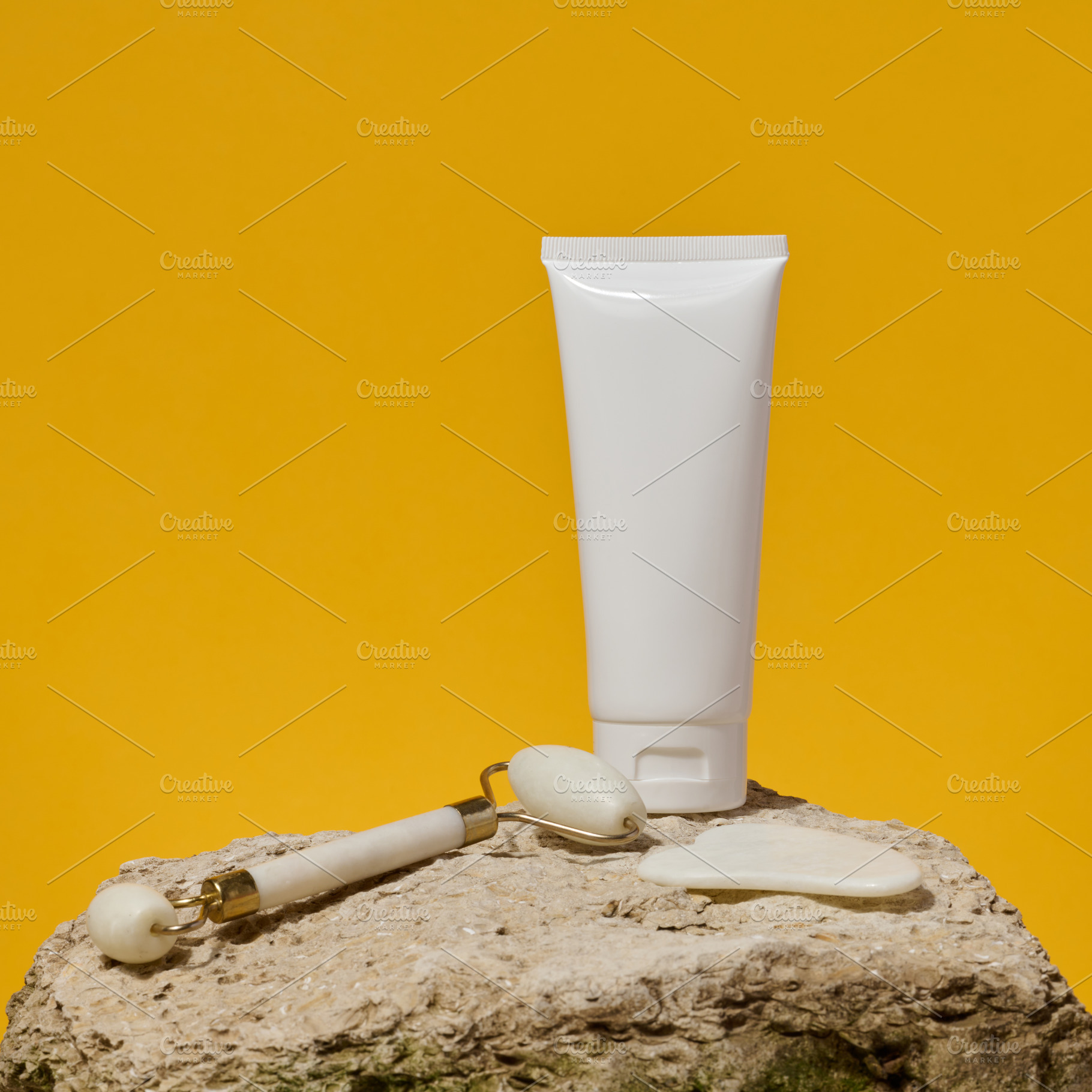 White tube, jade gouache massager and massage jade roller on a y, a Health & Medical Photo by ndanko