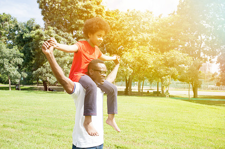 African american family doing piggyback and having fun in the outdoor park, a Person Photo by Twinster Photo