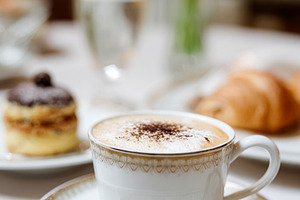 Cappuccino with croissant and pastry on a white table, enjoying, a Food & Drink Photo by Studio ANNA