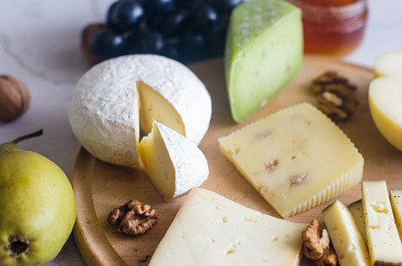 Delicious cheese mix with grapes, jam, snacks, crackers, walnuts, a Food & Drink Photo by vimart