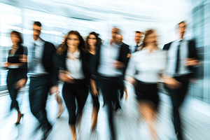 Business professionals walking quickly through a modern office space, a Business Photo by AlyaAnd
