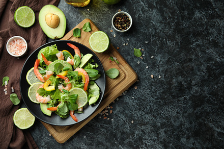 Concept of tasty eating with shrimp salad on black smokey backgr, a Food & Drink Photo by AtlasStudio PRO