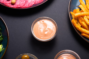 Creamy garlic sauce in a small glass bowl on a dark background., a Food & Drink Photo by MDBildes
