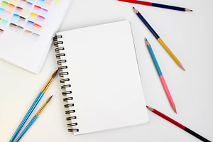 Art supplies on white table,top view