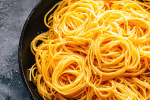 Cooked spaghetti in a cast iron skillet, a Food & Drink Photo by AlyaAnd