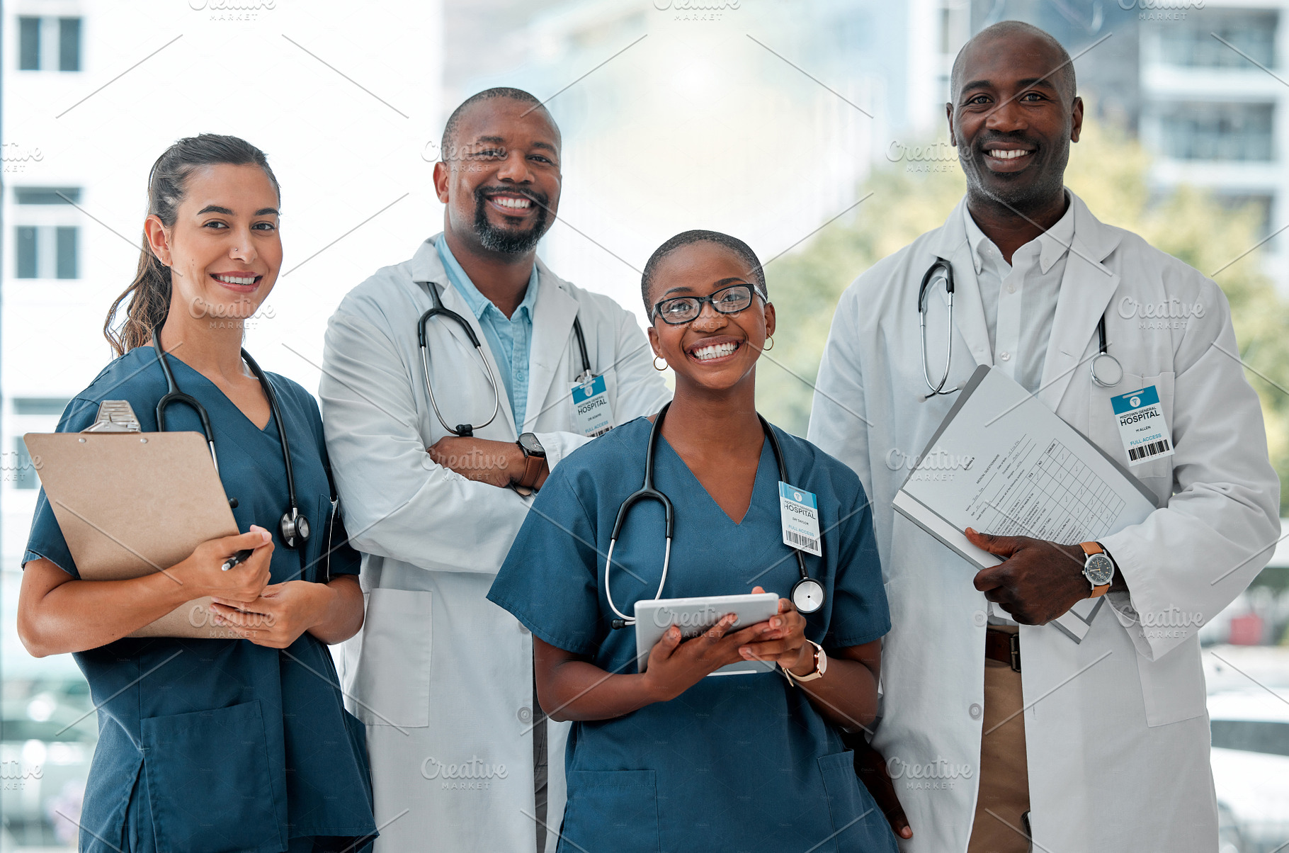 Group of doctors and nurses standing in a line with their arms crossed while working at a hospital. Content expert medical professionals smiling at work together at a clinic, a Photo by Peopleimages.com