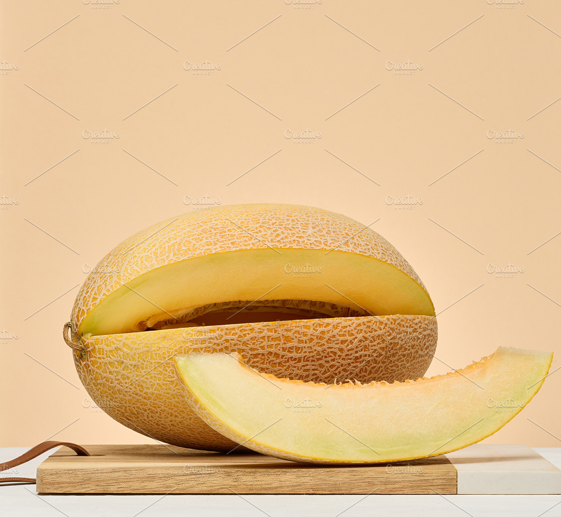 Cantaloupe melon and a separate slice on a beige background, a Food & Drink Photo by ndanko