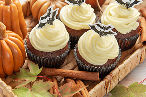 Halloween cupcakes with bat decoration and autumn elements, a Food & Drink Photo by Olena Rudo
