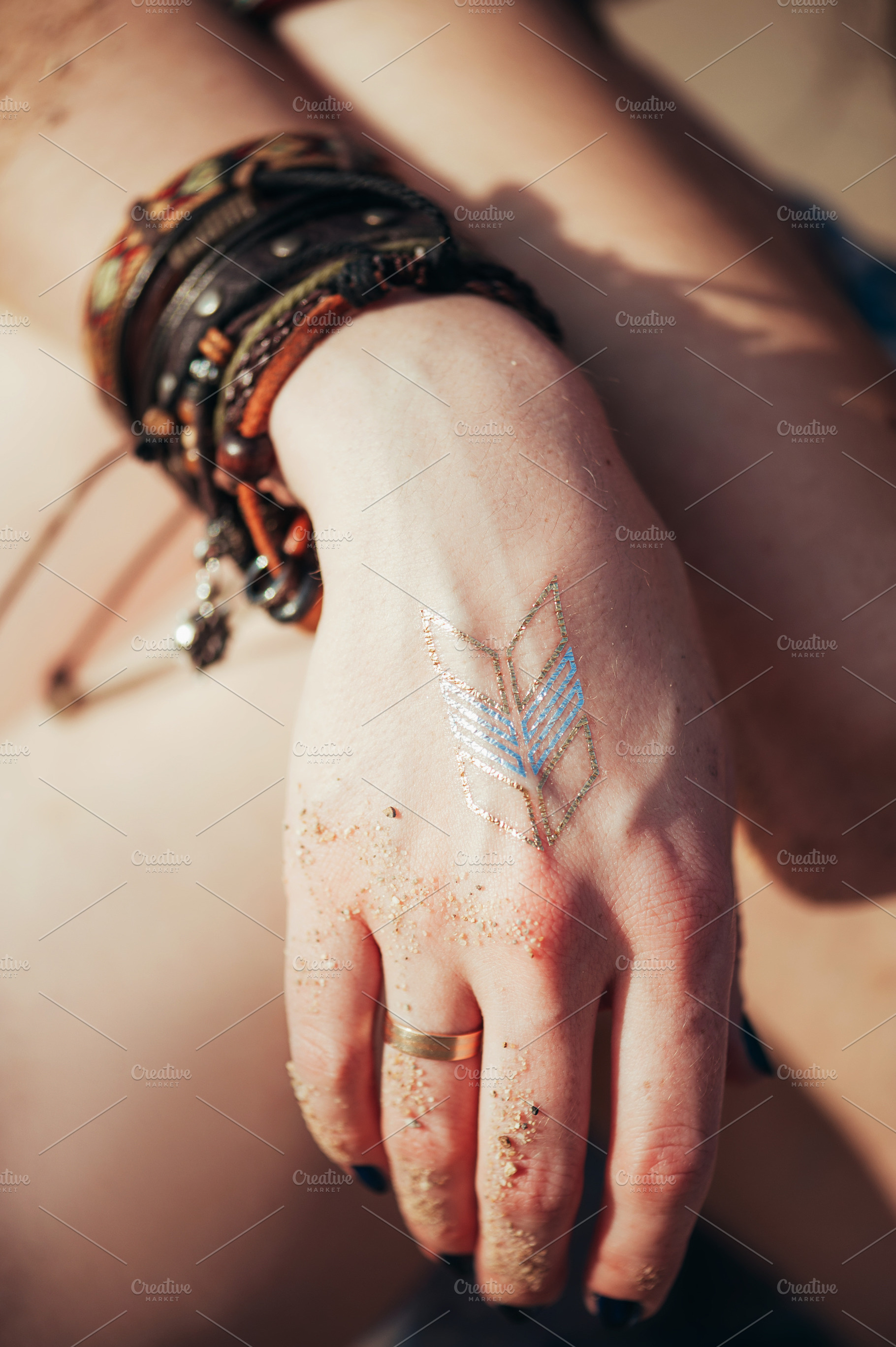 Close up hands with boho accessories containing jewelry, bohemian, and boho, a Nature Photo by MarinaMassel