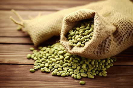Green coffee beans in burlap bag on wooden table. Generative AI, a Food & Drink Photo by AlyaAnd