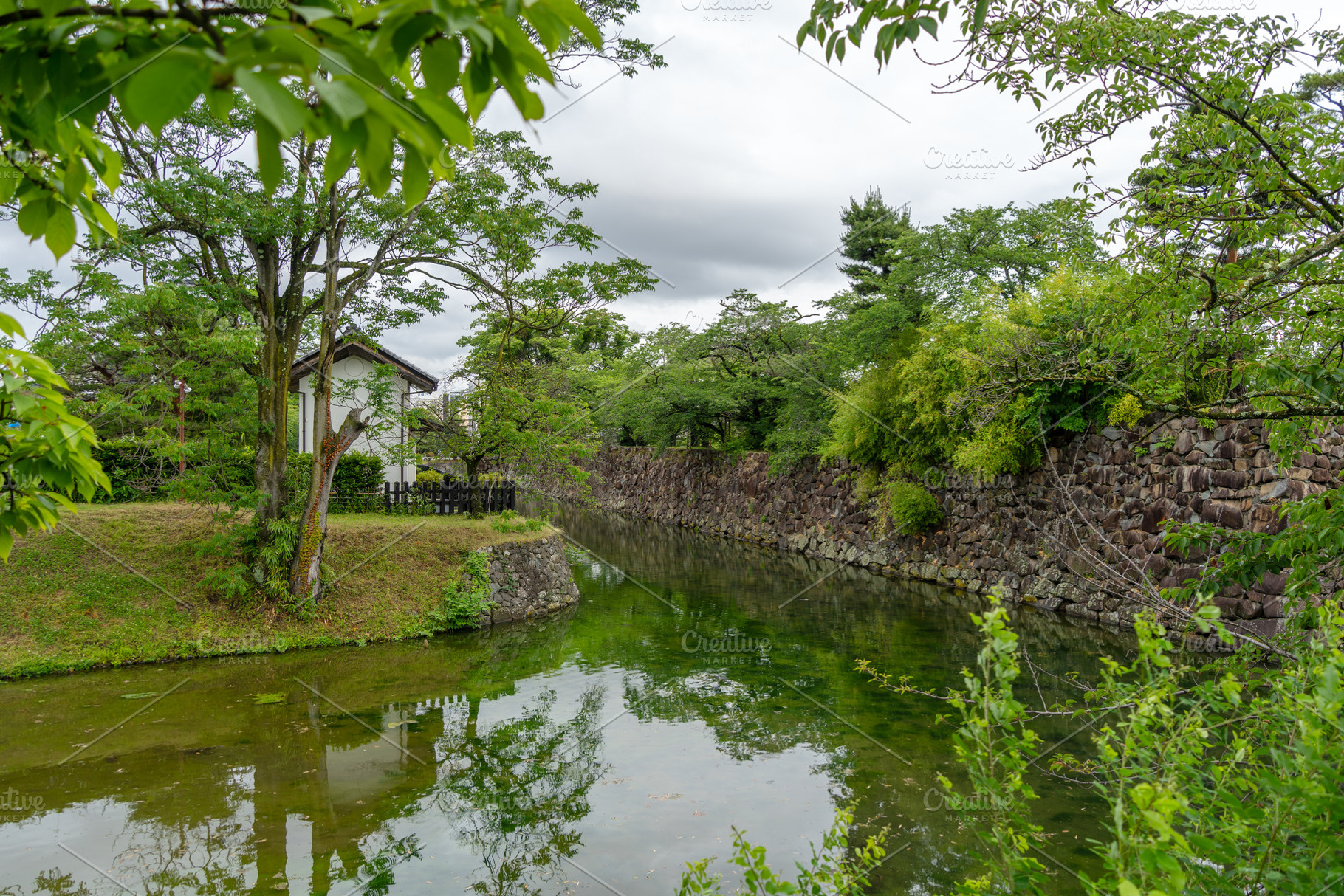 Stone moat and trees around Matsumoto Castle in Japan, a Nature Photo by GoodGoods