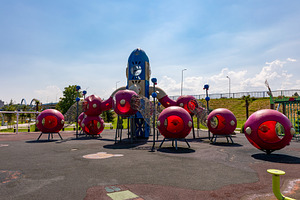 Colorful, futuristic playground equipment with red spheres and blue rocket in a, a Sports & Recreation Photo by Ales Munt