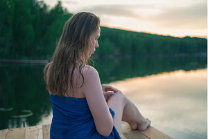 Woman Relaxing by Lake Wrapped in, a Person Photo by Jan Jack Russo Media