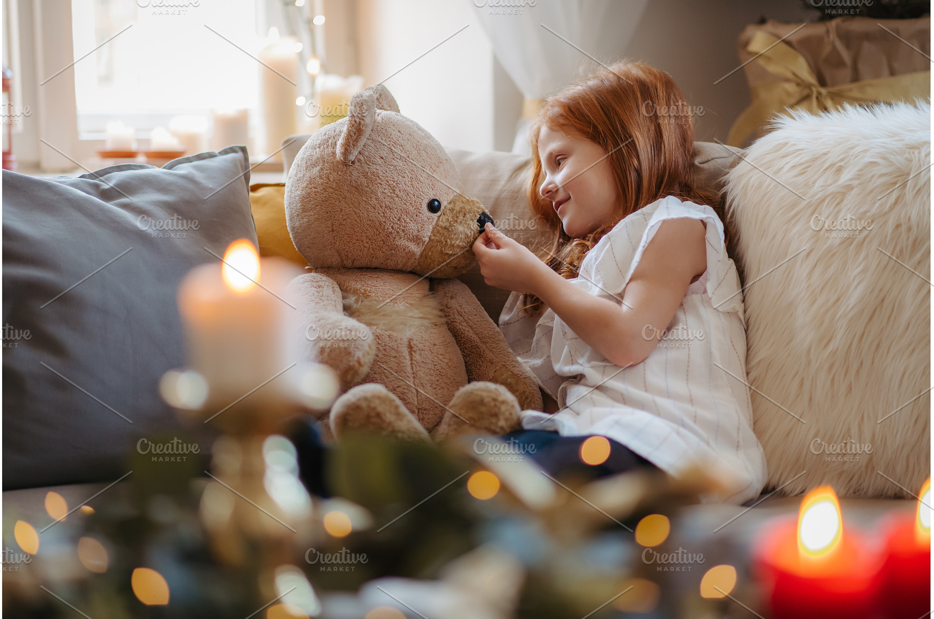 Small girl sitting on sofa indoors, a Person Photo by HalfPoint