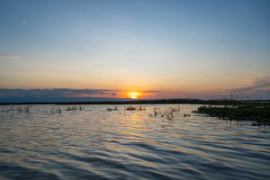 Sunset over Lake Tempe in Sulawesi, Indonesia's peaceful waters, a Nature Photo by GoodGoods
