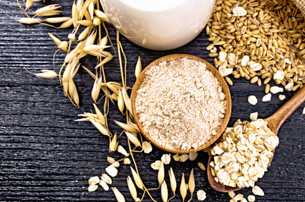 Flour oat in bowl on dark board, a Food & Drink Photo by rezkrr