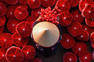 Making red umbrellas in Vietnam, a Photo by Beautiful things