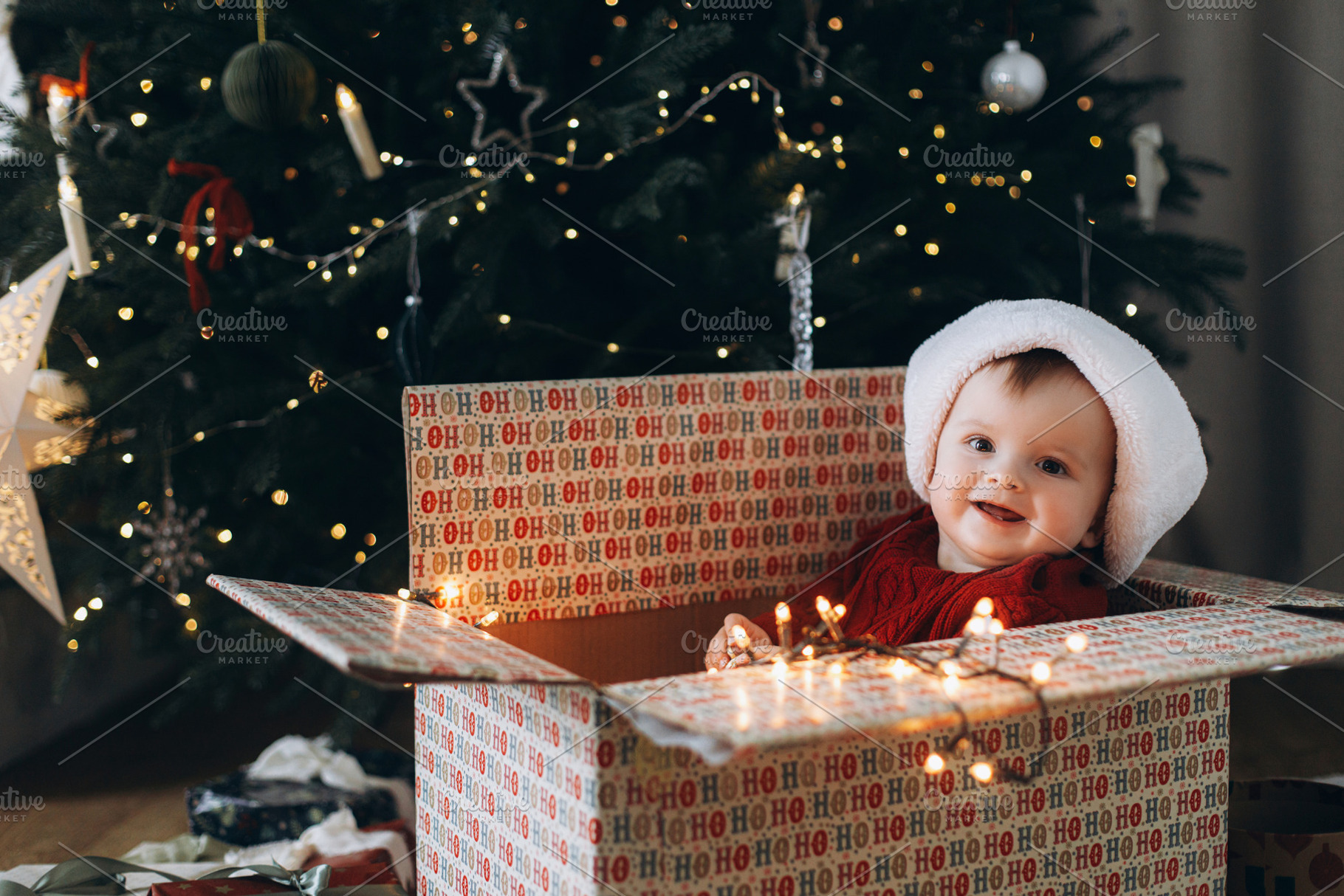 Merry Christmas and Happy Holidays! Cute baby in santa hat sitti, a Holiday Photo by Sonjachni