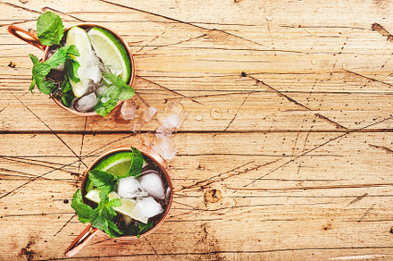 Moscow mule cocktails in copper mug with lime, ice, ginger beer,, a Food & Drink Photo by 5PH