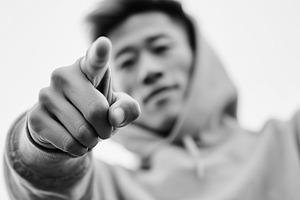 Young asian man in a hoodie points, a Person Photo by MistyDay