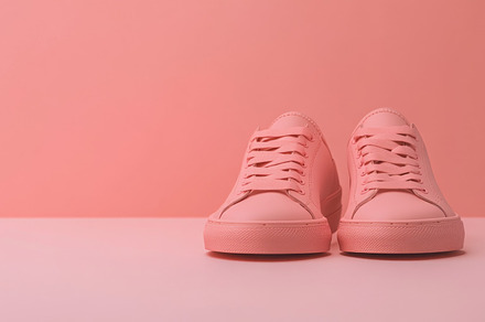 Pink sneakers on color background, a Photo by Dvoevnore photos